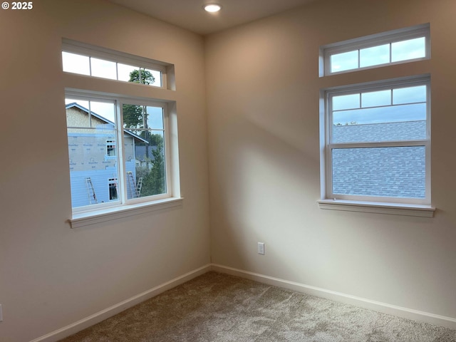 spare room featuring carpet floors, recessed lighting, and baseboards