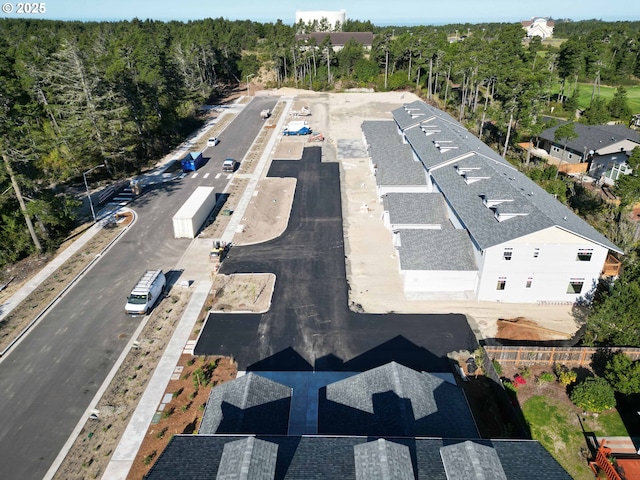birds eye view of property featuring a wooded view