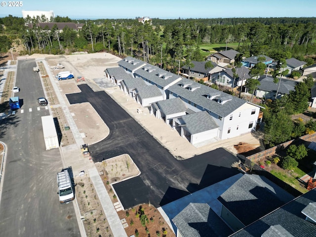 birds eye view of property with a residential view and a wooded view