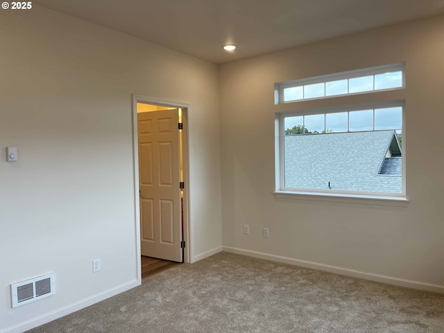 carpeted spare room with recessed lighting, visible vents, and baseboards