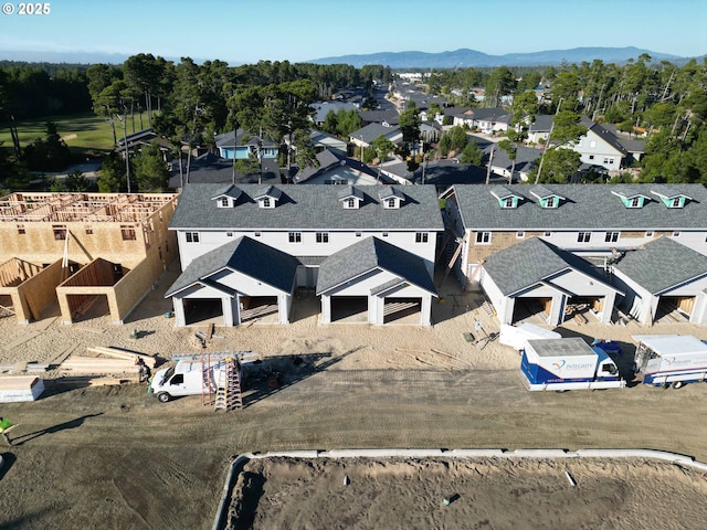 drone / aerial view featuring a residential view and a mountain view