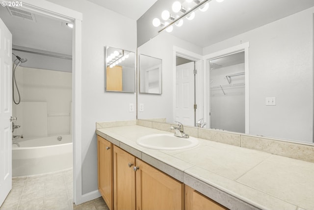 bathroom featuring tile patterned floors, vanity, and shower / bathtub combination