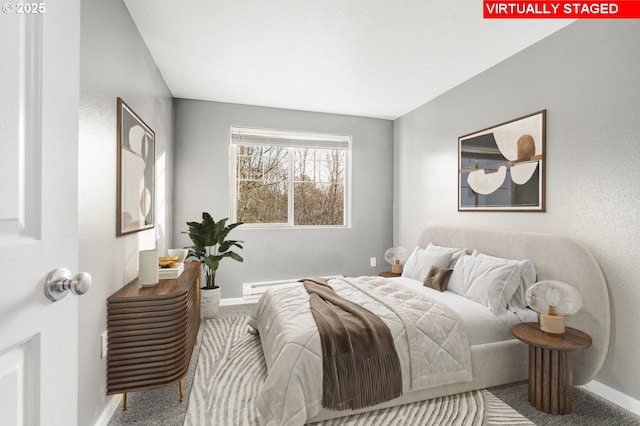 carpeted bedroom featuring a baseboard heating unit