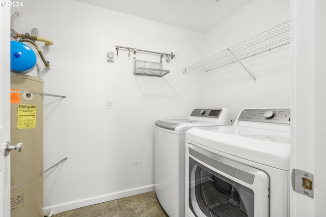 clothes washing area featuring washer and clothes dryer and water heater