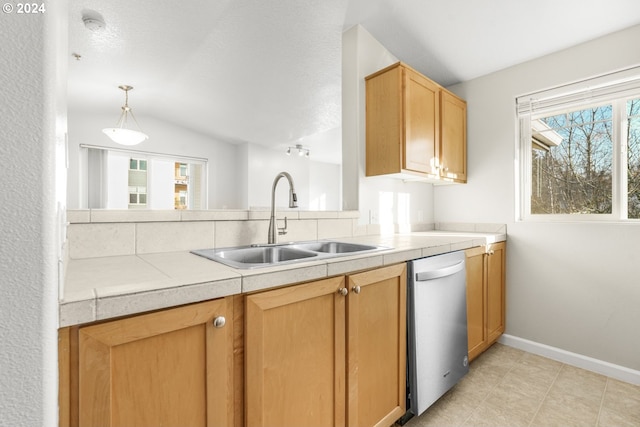 kitchen featuring dishwasher, hanging light fixtures, sink, and a wealth of natural light