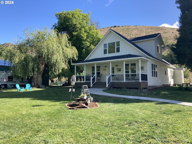 view of front facade with covered porch and a front lawn