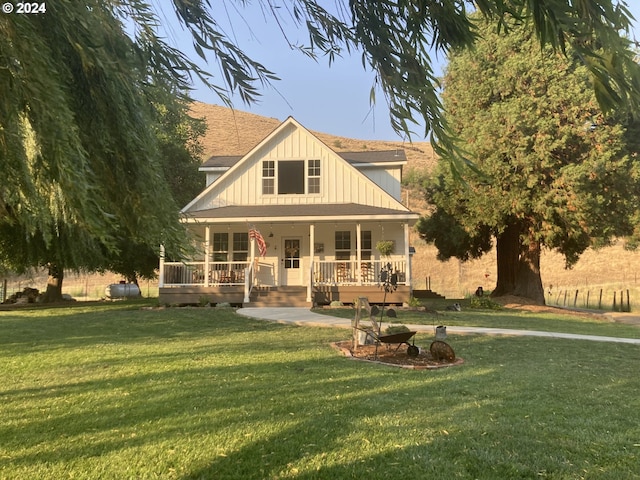 view of front of property with a porch and a front lawn