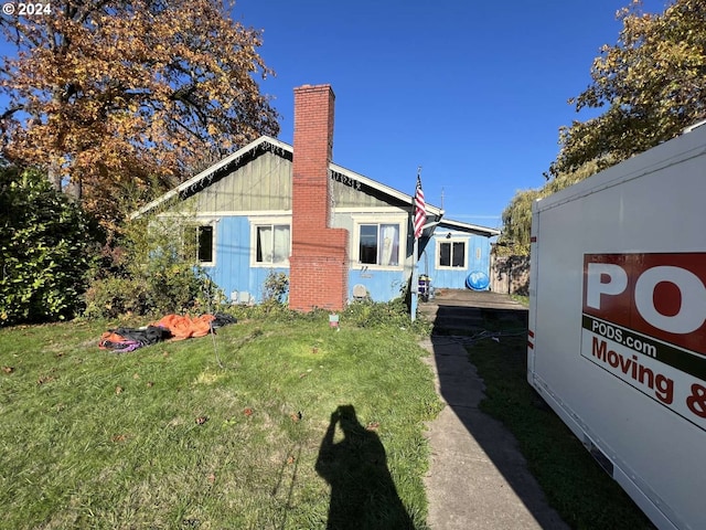 view of side of property featuring a yard