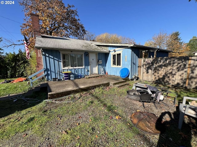 back of house with a yard and a patio area