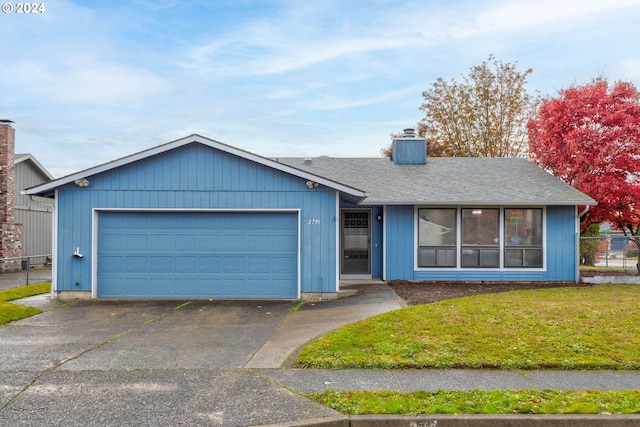 ranch-style home featuring a garage and a front yard