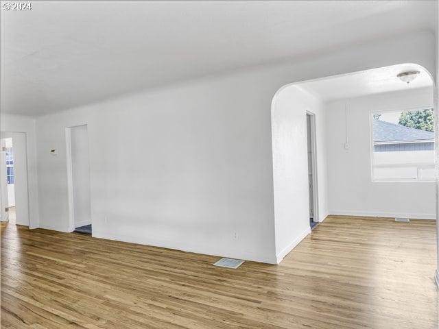 unfurnished room with light wood-type flooring