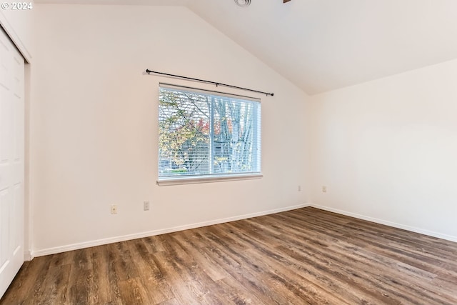 interior space featuring dark hardwood / wood-style flooring and lofted ceiling