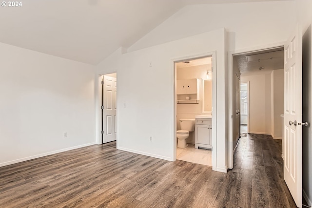 unfurnished bedroom with ensuite bathroom, lofted ceiling, and dark hardwood / wood-style flooring