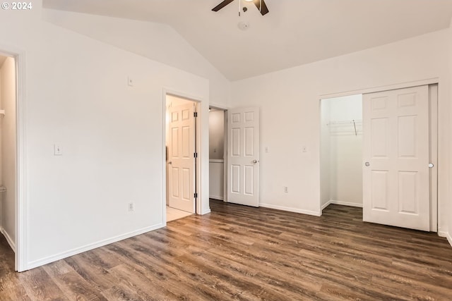 unfurnished bedroom featuring dark hardwood / wood-style flooring, lofted ceiling, ceiling fan, and a closet