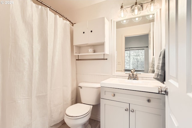 bathroom featuring vanity, hardwood / wood-style flooring, and toilet