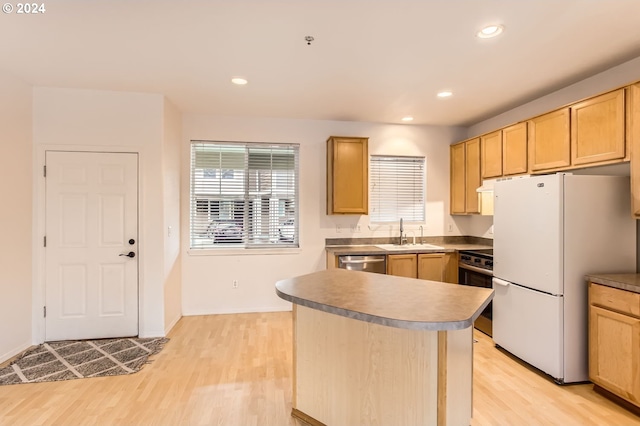 kitchen featuring dishwasher, light hardwood / wood-style flooring, sink, and white refrigerator