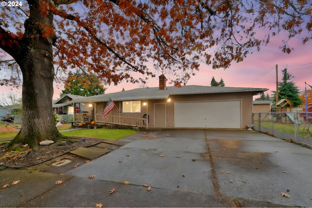 single story home featuring a garage and covered porch