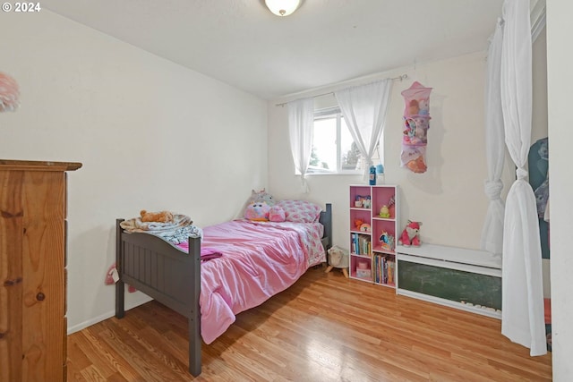 bedroom with hardwood / wood-style floors