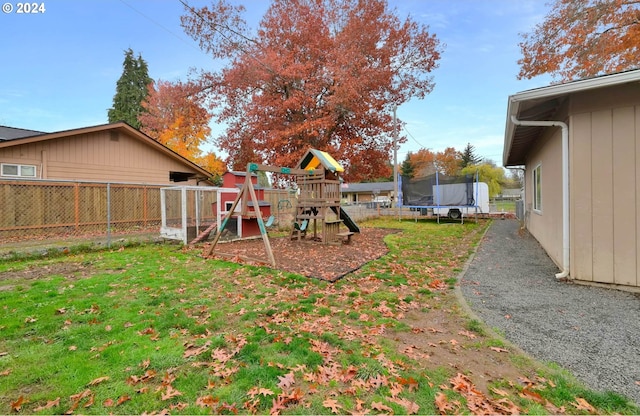 view of yard featuring a playground and a trampoline