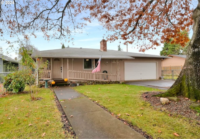 ranch-style house featuring a garage and a front lawn