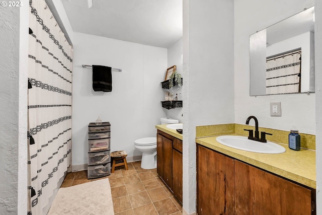 bathroom featuring vanity, toilet, and tile patterned flooring