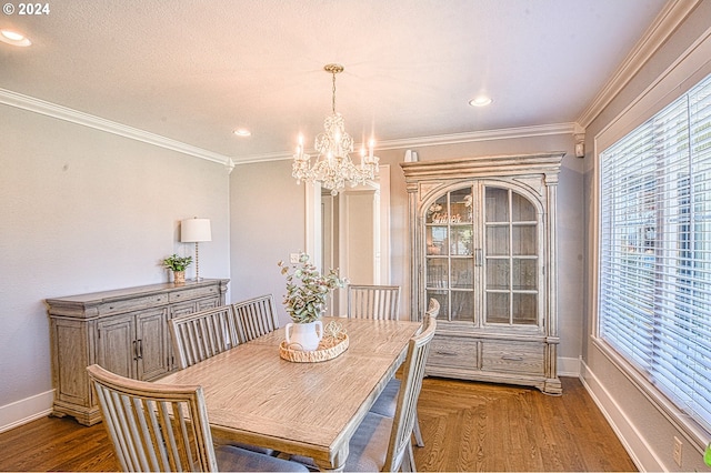 dining area with ornamental molding, dark wood-type flooring, and a chandelier