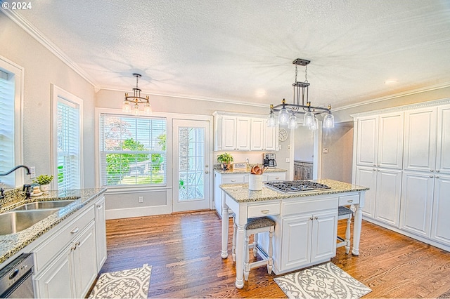 kitchen featuring a kitchen breakfast bar, sink, light wood-type flooring, and white cabinets