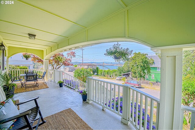 view of patio / terrace featuring covered porch and a water view