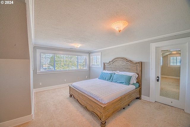 bedroom with crown molding, a textured ceiling, and carpet flooring