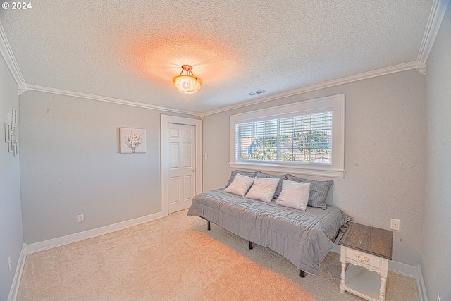 sitting room with a textured ceiling, light carpet, and ornamental molding