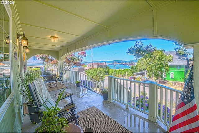 view of patio / terrace with a balcony and a water view