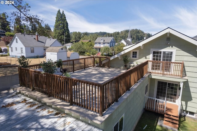 back of property featuring an outdoor structure and a balcony