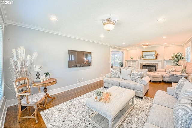 living room with crown molding and hardwood / wood-style floors