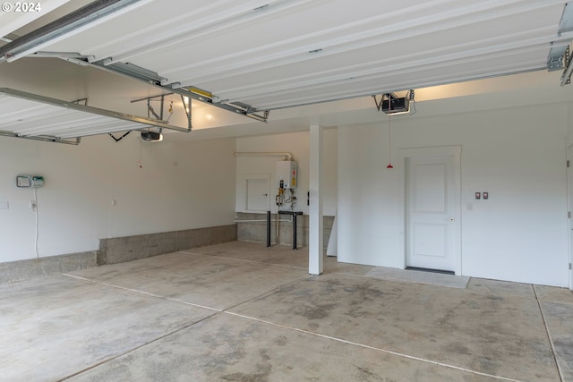 garage with a garage door opener and water heater