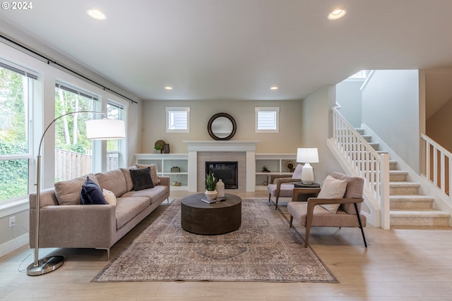 living room with a fireplace and light hardwood / wood-style flooring