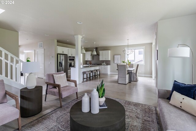 living room featuring sink and hardwood / wood-style floors