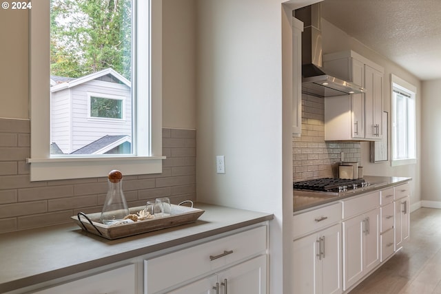 kitchen with white cabinetry, stainless steel gas cooktop, and plenty of natural light