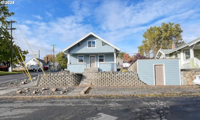 bungalow-style house featuring a storage shed