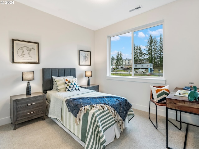 bedroom featuring light carpet