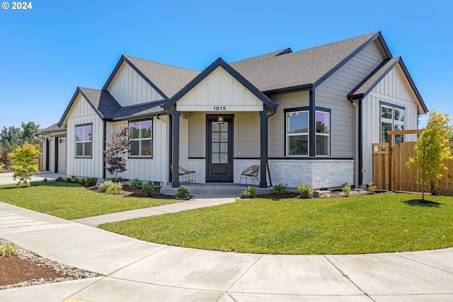 view of front of house with a porch and a front yard