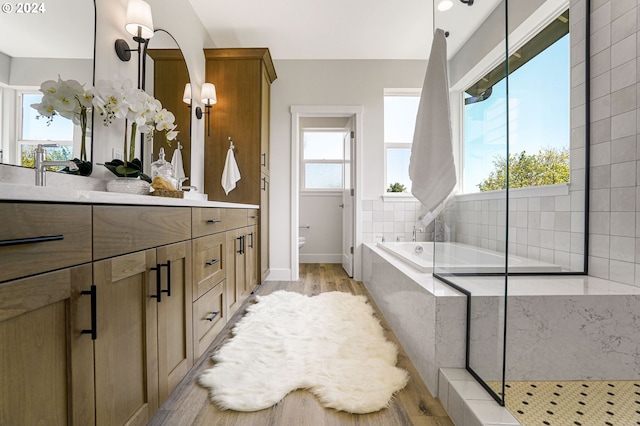 full bathroom featuring vanity, separate shower and tub, toilet, and wood-type flooring