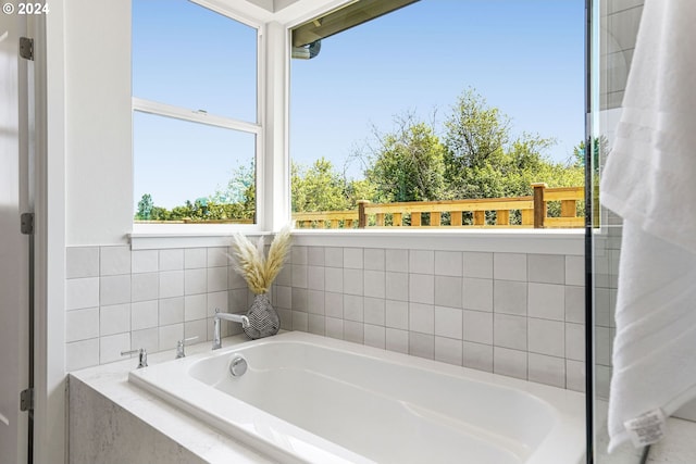 bathroom featuring tiled bath