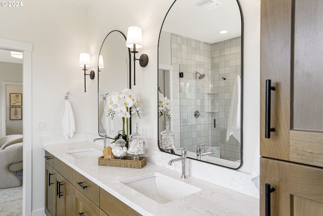 bathroom with vanity and a shower with door