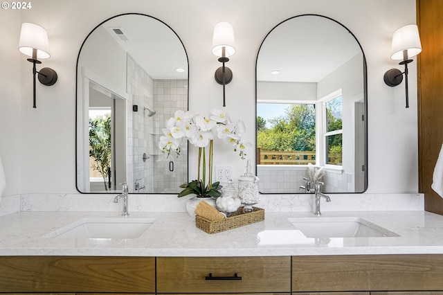 bathroom featuring vanity, a healthy amount of sunlight, and an enclosed shower