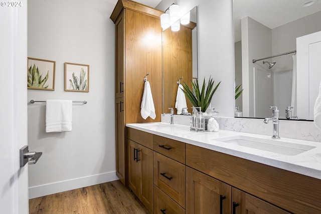 bathroom featuring vanity, a shower, and wood-type flooring