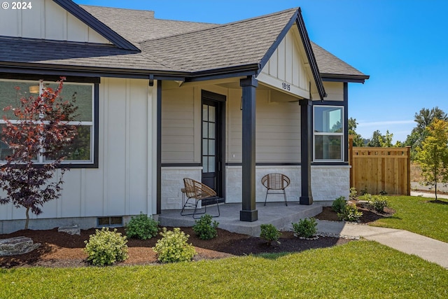 exterior space featuring covered porch and a front yard