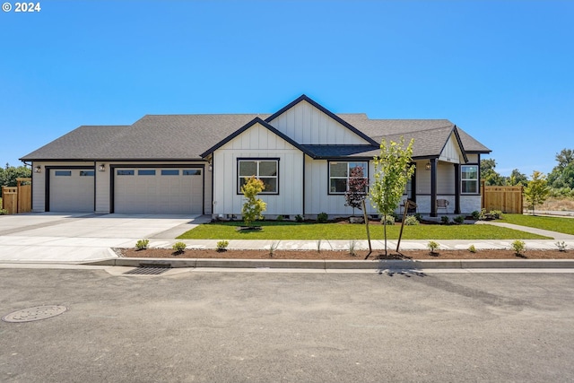 view of front of property with a front yard and a garage