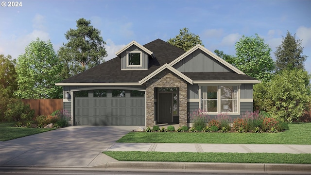 view of front of home with a front yard and a garage