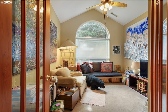 carpeted living room with lofted ceiling and ceiling fan