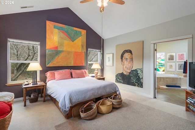 carpeted bedroom featuring high vaulted ceiling, ceiling fan, and ensuite bathroom